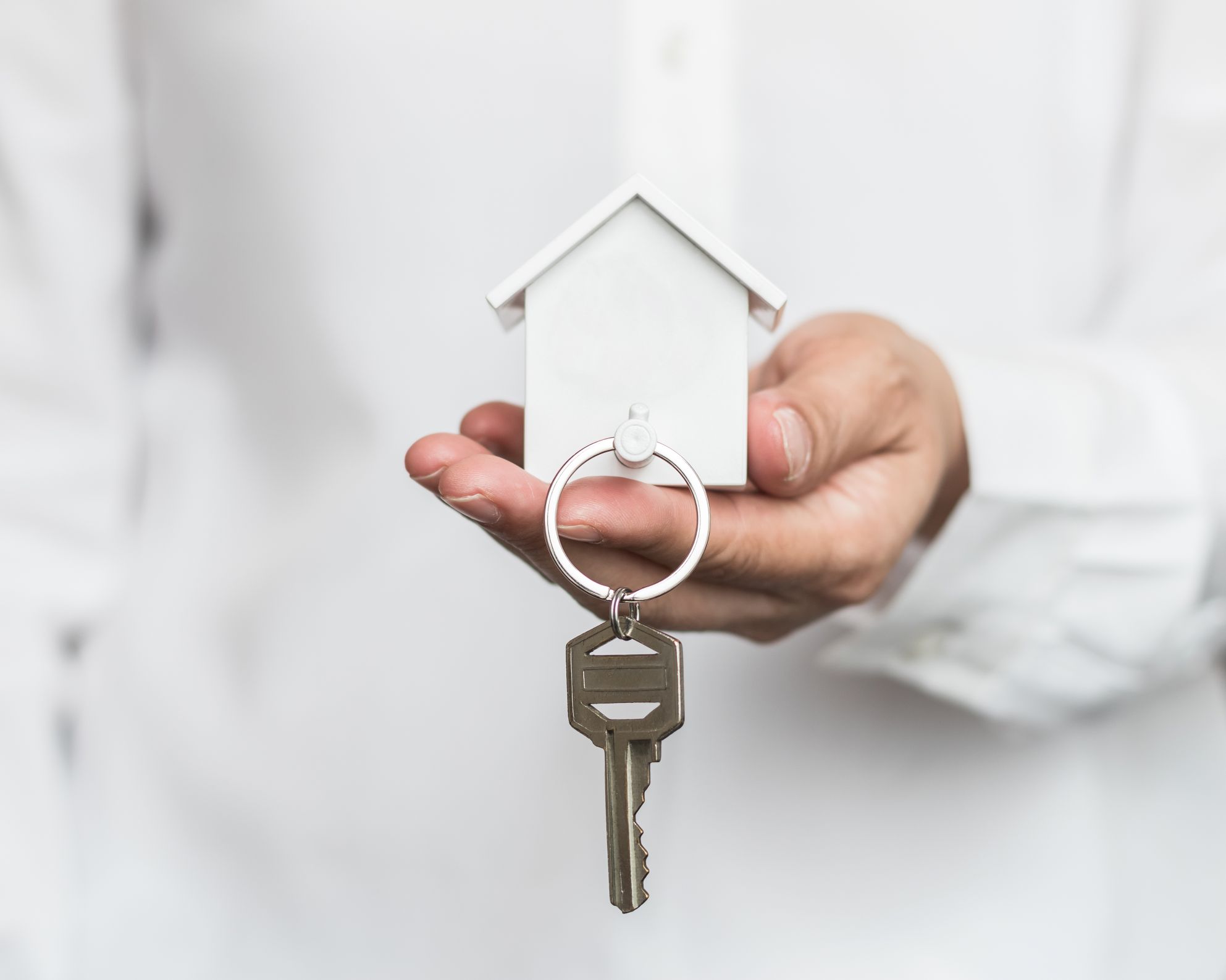 hand holding keys to a property for sale