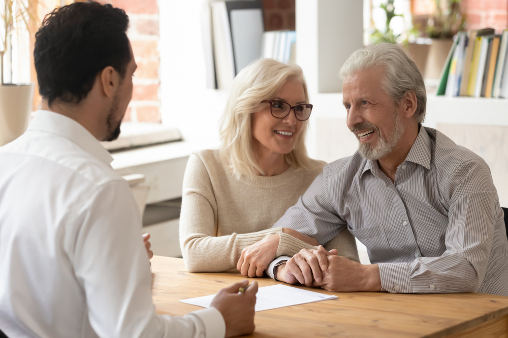 senior couple talking with realtor